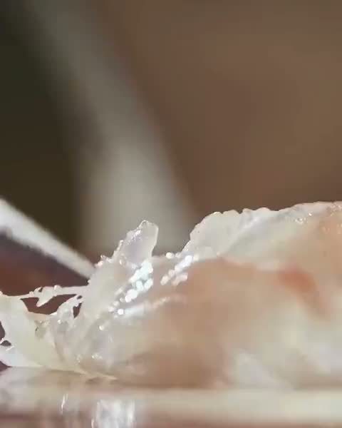 A knife slicing fish, in motion
